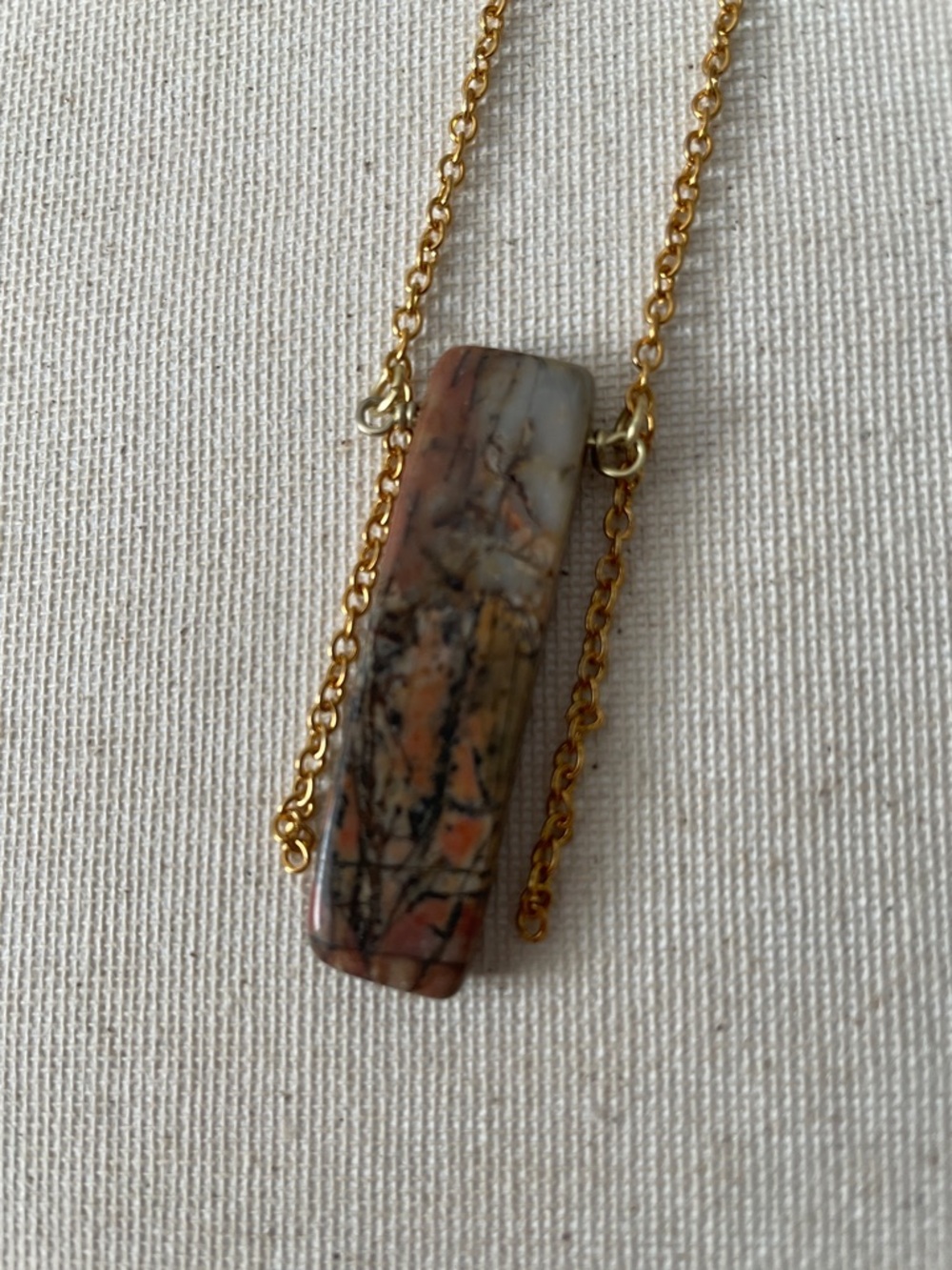 Brown, black, orange, and beige stone dangle chain necklace